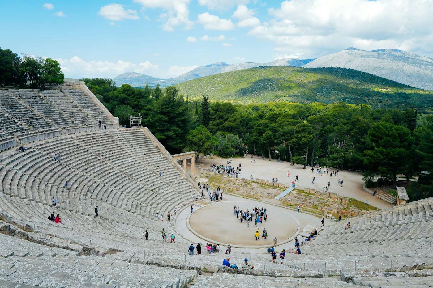 The ancient theatre of Epidaurus curving around its circular orchestra